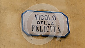 Street sign on yellow wall in Italy photo